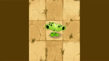 a green cartoon character with two eyes is standing on a tiled floor .