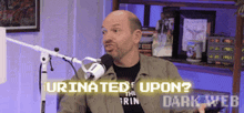 a man is sitting in front of a microphone with the words urinated upon written on the screen