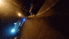 a blurred image of a street at night with a sign that says ' coca cola '