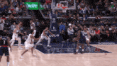 a basketball game is being played in front of a sprite sign
