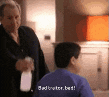 a man is spraying a child with a spray bottle and the child says bad traitor bad