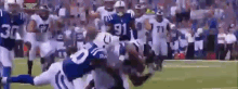 a group of football players are playing a game of football .