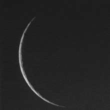 a black and white photo of the moon with a dark background