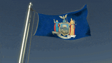 a new york state flag flies in the wind