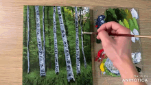 a person is painting birch trees on a canvas