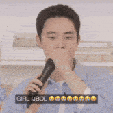 a man singing into a microphone with a sign that says girl ijbol on it
