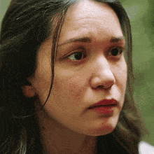 a close up of a woman 's face with her eyes closed