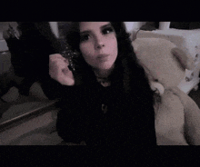 a girl wearing a black sweatshirt with the word rnf on it