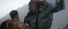 a man is fighting a monster with a sword in his hand .