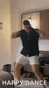 a man is dancing in a room with the words `` happy dance '' written on it .
