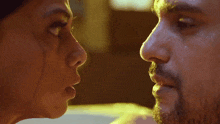 a man and a woman are looking at each other with their eyes closed