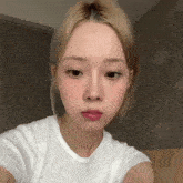 a young woman with blonde hair is taking a selfie with her phone .