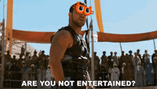 a man in a gladiator costume says " are you not entertained " in front of a crowd