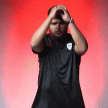 a man with a beard wearing a black shirt with a smiley face on it