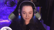 a woman wearing headphones is sitting in a chair