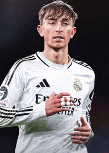 a soccer player wearing a white jersey that says " emirates better "