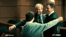 three men hugging each other in a courtroom with nbc written on the bottom