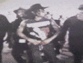 a blurry picture of a man wearing a cowboy hat and a tank top with the letter v on it
