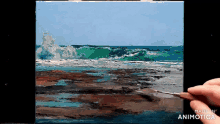 a person is painting a picture of the ocean and the words made in animotica are on the bottom