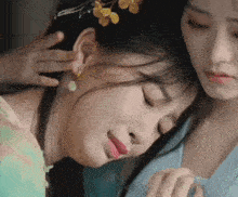 a close up of two women 's faces with one wearing a flower crown