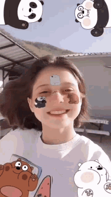 a girl is wearing a t-shirt with panda bears on her face .
