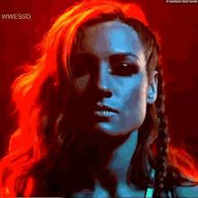 a close up of a woman 's face with red and blue hair .