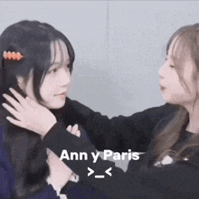 a couple of girls are hugging each other .