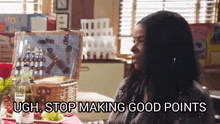 a woman is sitting at a table with a picnic basket and says " ugh stop making good points " .