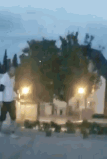 a blurry picture of a man in a white shirt and black shorts