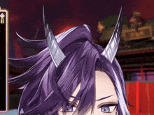 a close up of a person 's face with horns and a sign that says ' a ' on it