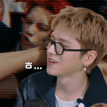 a close up of a person wearing glasses with a foreign language on the bottom