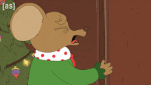 a cartoon mouse is standing in front of a christmas tree and a sign that says ' as ' on it