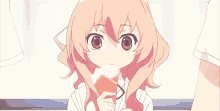 a girl with pink hair is brushing her teeth with a toothbrush and making a funny face .