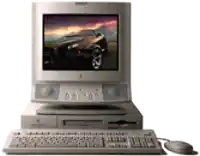 an apple computer with a picture of a car on the monitor