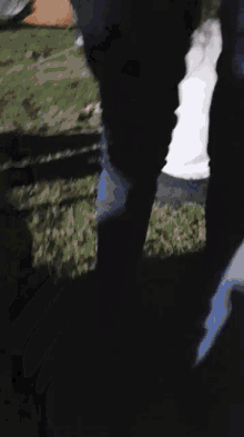 a blurry picture of a person 's feet in the grass