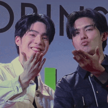 two men are making funny faces in front of a sign that says ' orin ' on it