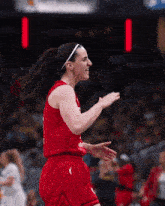 a female basketball player wearing a red jersey and shorts with the number 2 on them