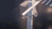 a blurred image of a cross with scissors cutting it