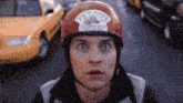 a man wearing a red helmet that says joe 's pizza