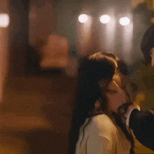 a man is touching a woman 's face in a close up .