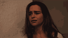a close up of a woman 's face in a dark room