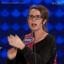 a woman with glasses and a name tag that says hannah on it