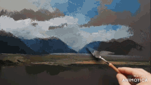 a person is painting a landscape with the words made in animotica below it