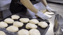 a person is rolling out dough on a tray that says made in animotica