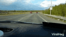 a car is driving down a highway with a sign on the side that says do not enter