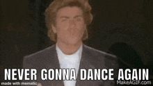 a man in a suit and white shirt is standing in front of a piano and says `` never gonna dance again '' .