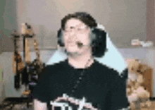 a man wearing headphones and a microphone is standing in front of a computer .