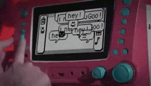 a person is playing a video game on a pink device that says hey !