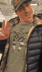 a man wearing a hat that says m & m co on it