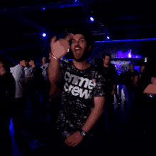 a man wearing a shirt that says " crime crew " is dancing